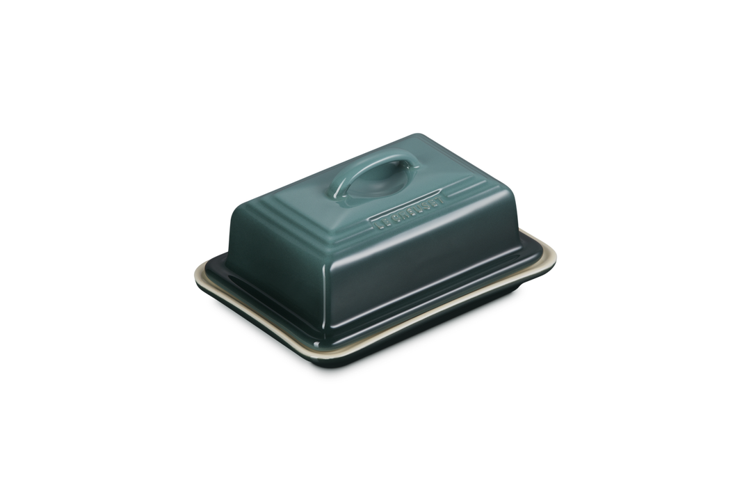 Green butter dish with lid on a white background