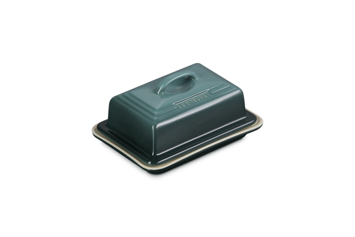 Green butter dish with lid on a white background