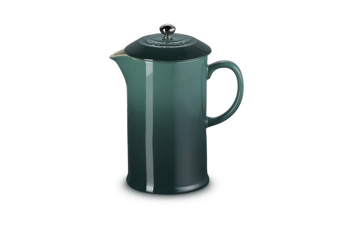 Green French press coffee maker on a white background