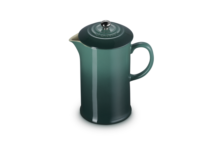 Green French press coffee maker on a white background