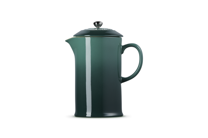 Green French press coffee maker on a white background