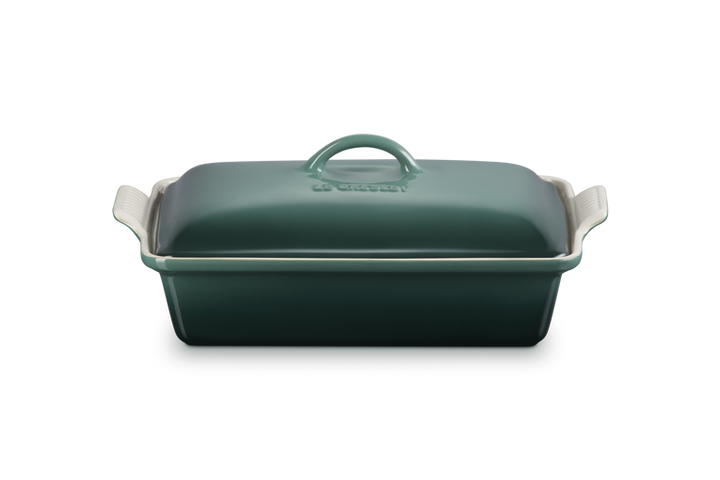 Green rectangular baking dish with a lid on a white background