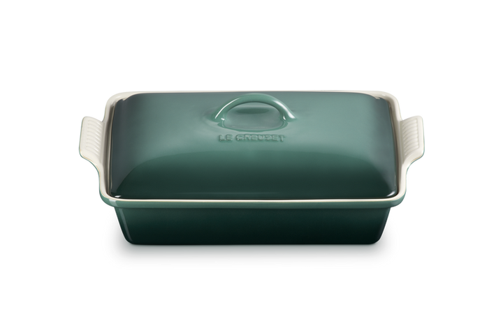 Green rectangular baking dish with a lid on a white background