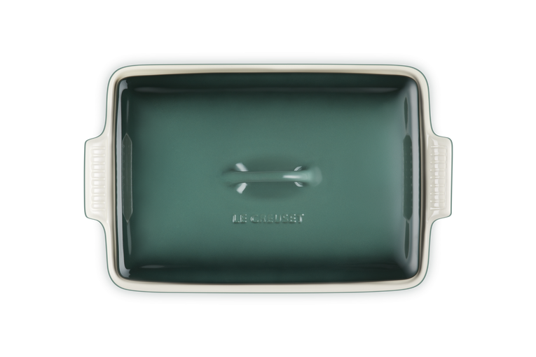 Rectangular green ceramic baking dish with handles on a white background