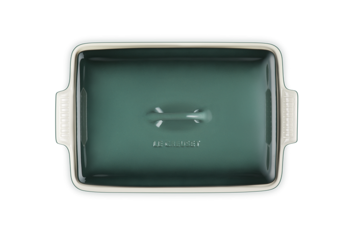 Rectangular green ceramic baking dish with handles on a white background