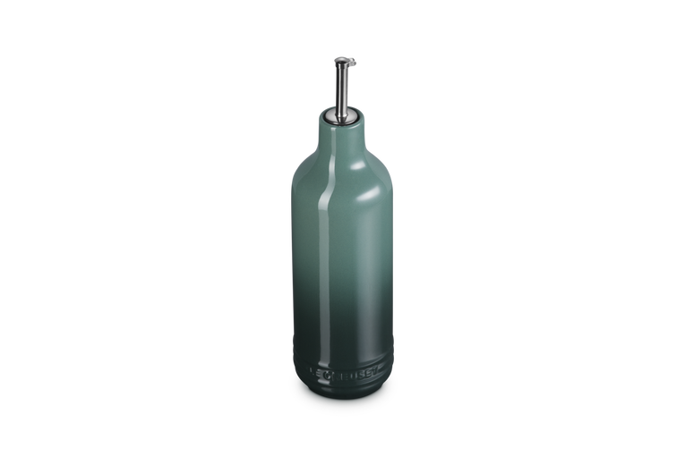 Green olive oil bottle on a white background