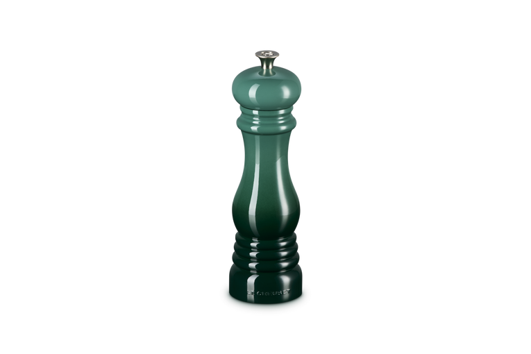 Green pepper grinder on a white background