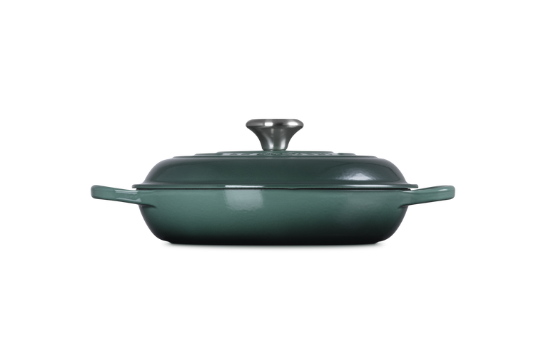 Green casserole dish with lid on a white background