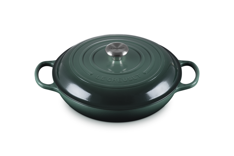 Green cast iron cookware with handles on a white background