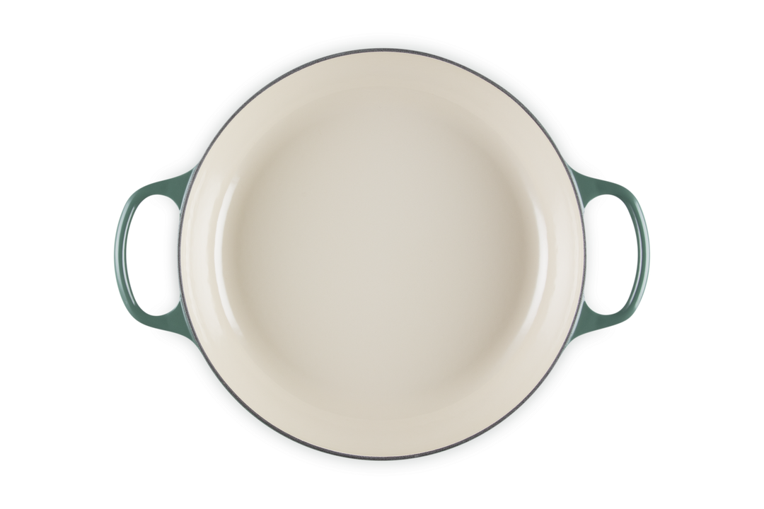 Round ceramic dish with handles on a white background