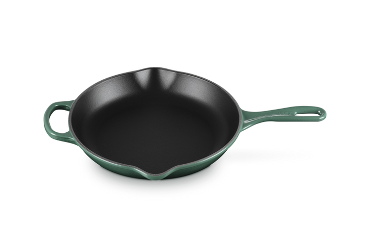 Green cast iron skillet on a white background