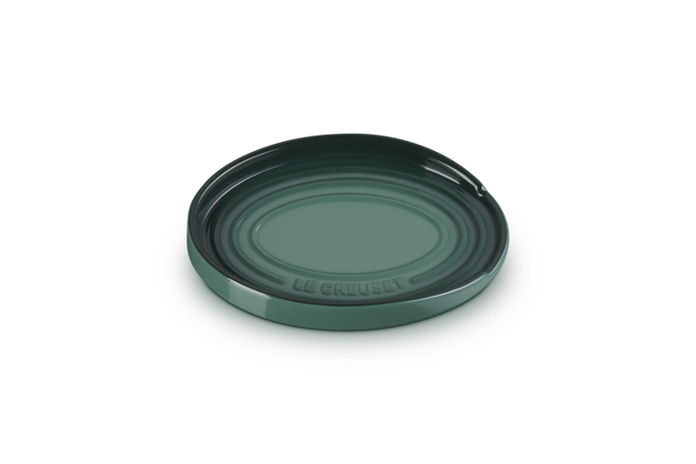 Green ceramic spoon rest with 'Le Creuset' branding on a white background