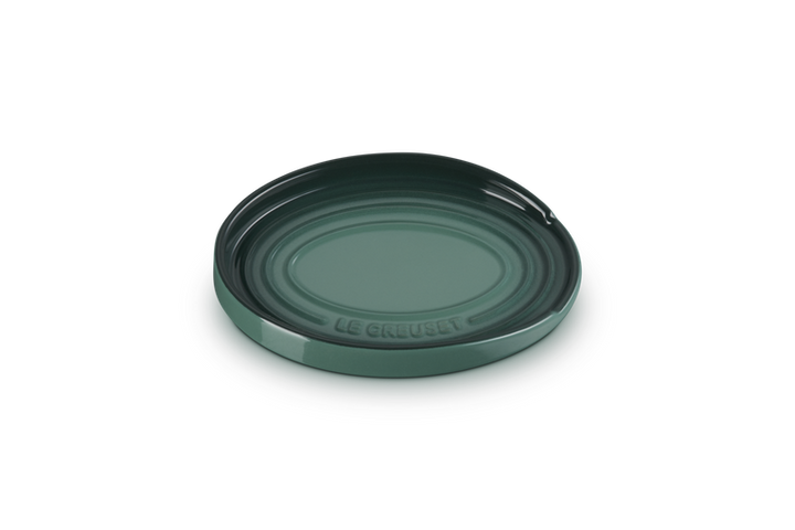 Green ceramic spoon rest with 'Le Creuset' branding on a white background