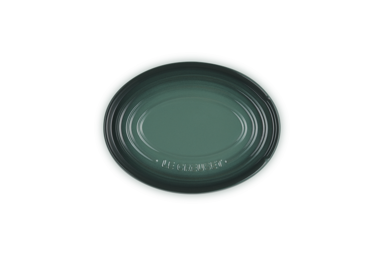 Green ceramic spoon rest
on a white background