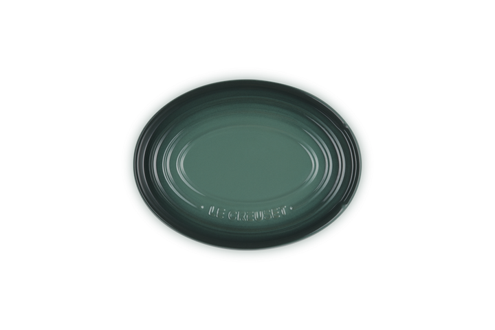 Green ceramic spoon rest
on a white background