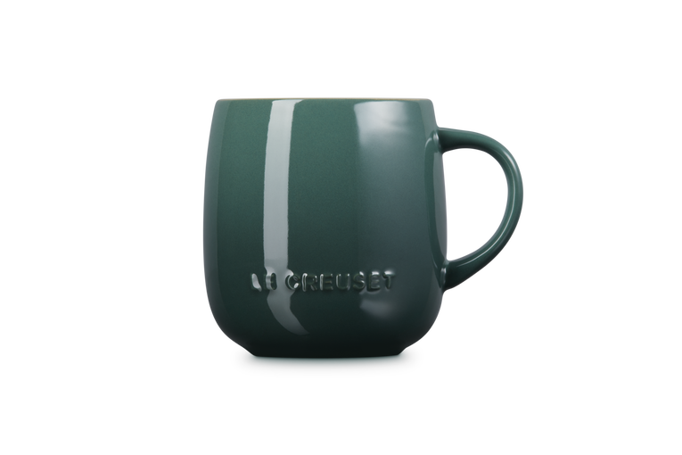 Green mug with 'Le creuset' branding on a white background