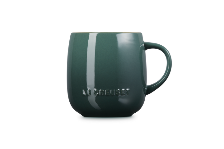 Green mug with 'Le creuset' branding on a white background