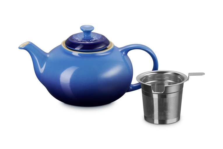 Blue teapot with a metal infuser on a white background