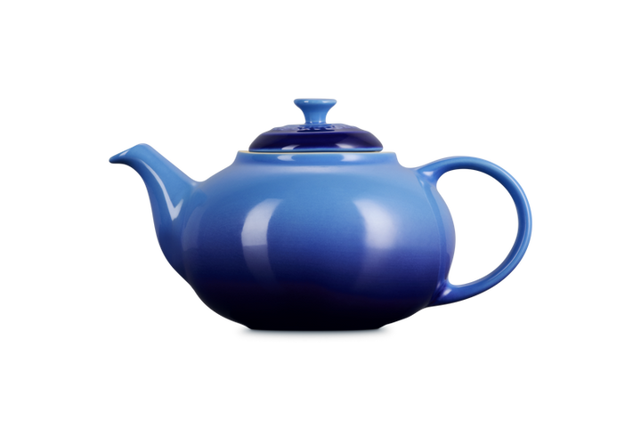 Blue teapot on a white background