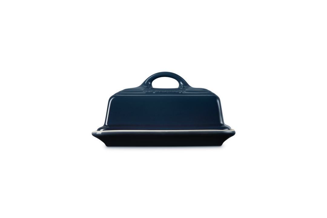 Navy blue butter dish with a handle on a white background