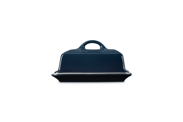 Navy blue butter dish with a handle on a white background