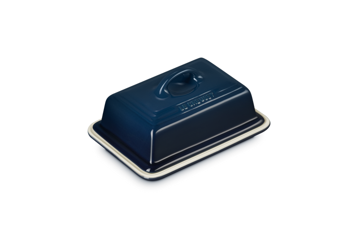 Blue ceramic butter dish on a white background