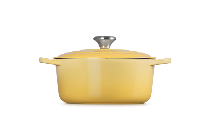 Yellow enameled cast iron Dutch oven on a white background