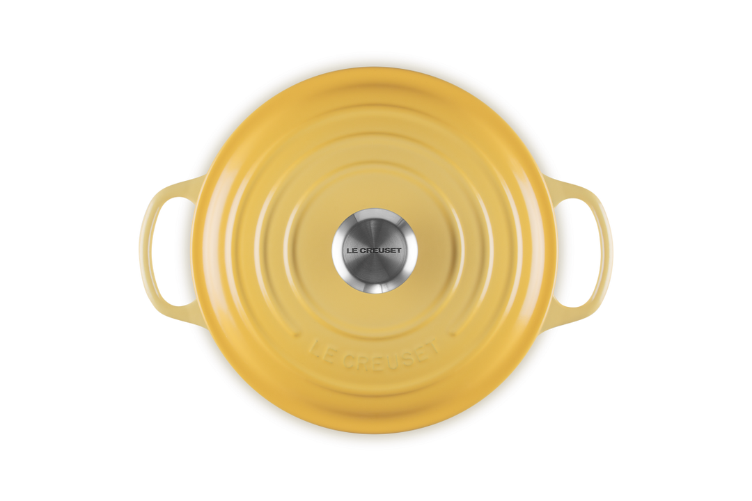 Yellow ceramic dish with handles on a white background