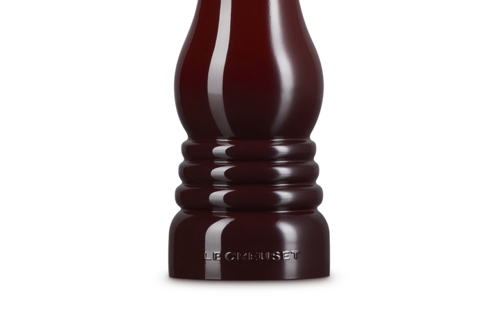 Dark burgundy salt grinder on a white background