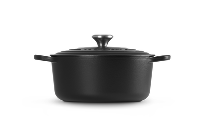 Black cast iron cookware pot on a white background