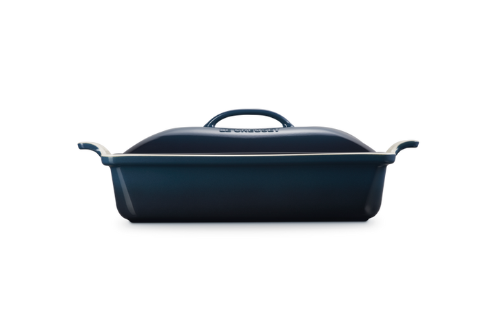 Blue rectangular baking dish with a lid on a white background