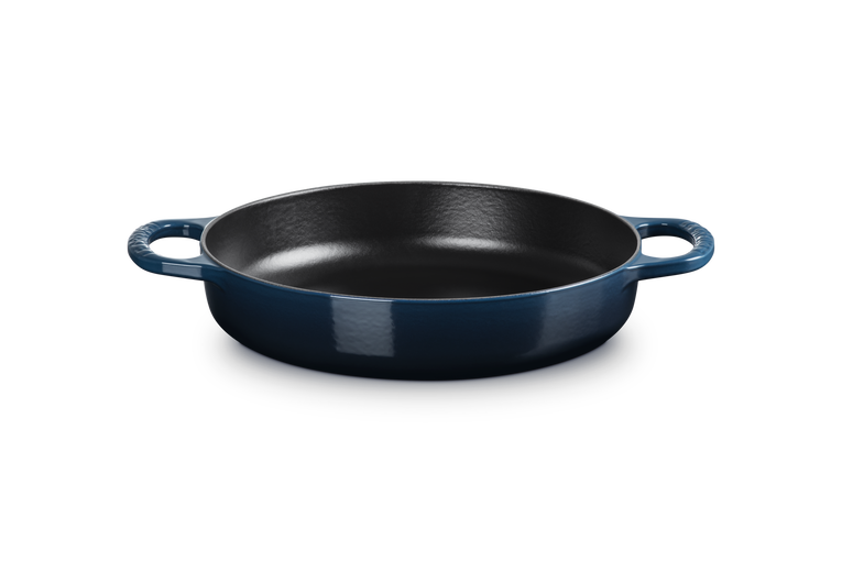 Blue cast iron skillet on a white background