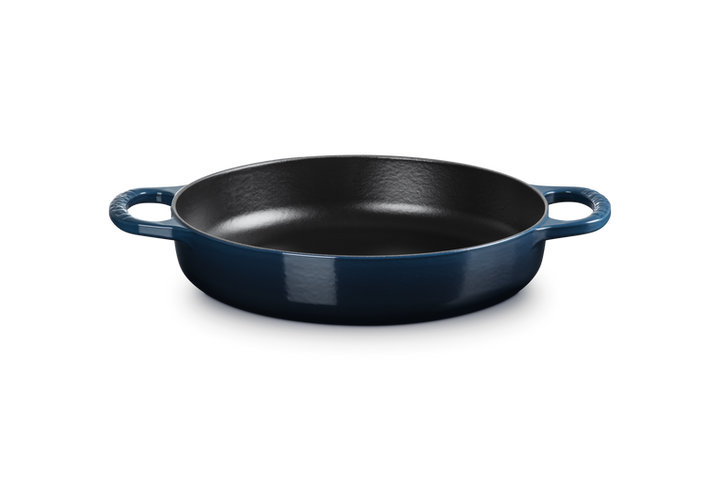 Blue cast iron skillet on a white background