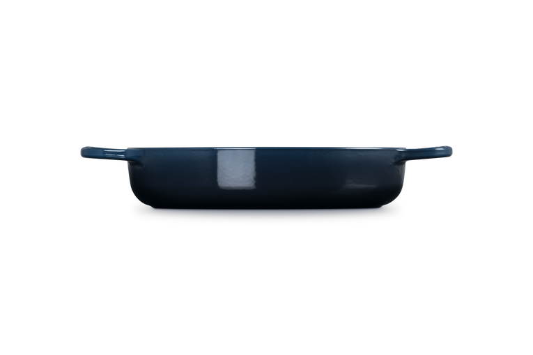 Navy blue cast iron dish on a white background