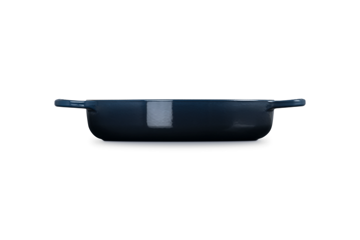 Navy blue cast iron dish on a white background