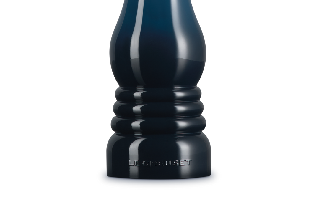 Dark blue salt grinder on a white background
