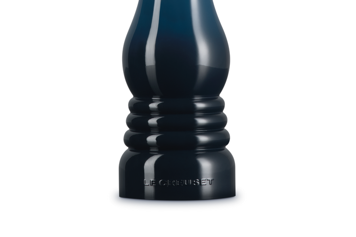 Dark blue salt grinder on a white background