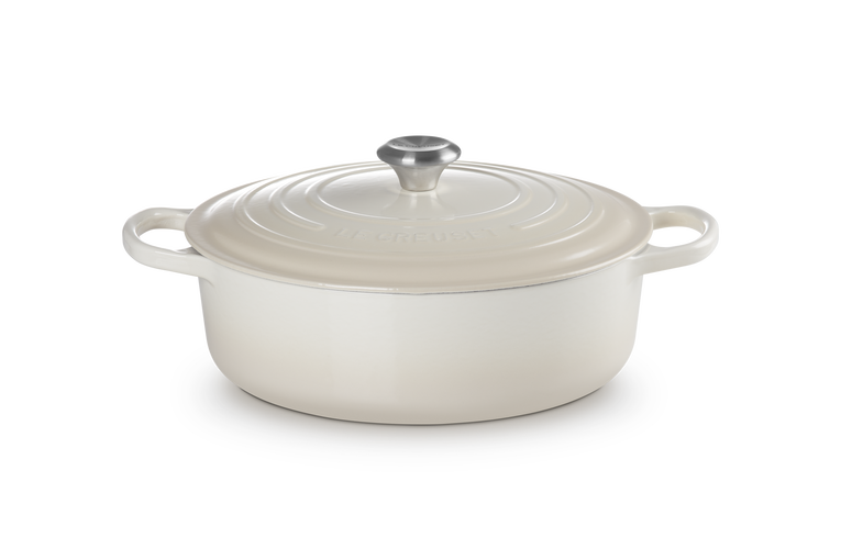 White ceramic cookware with lid on a white background