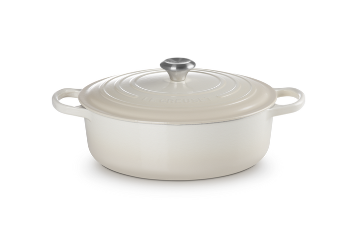 White ceramic cookware with lid on a white background