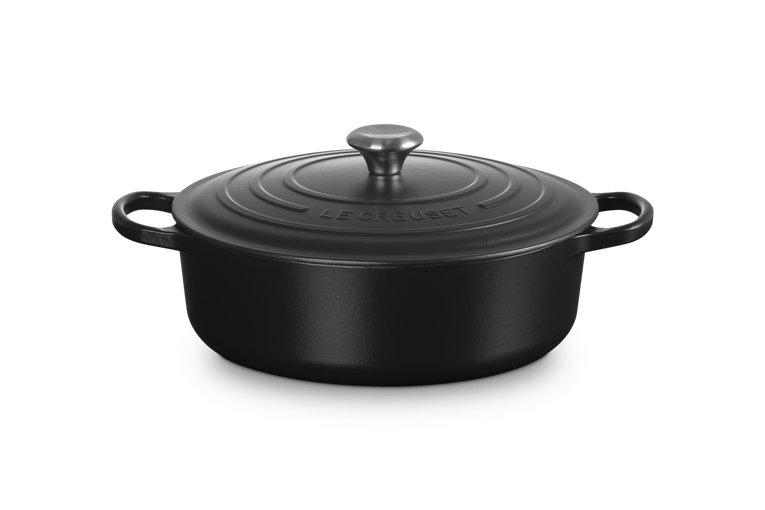 Black cast iron cookware with lid on a white background