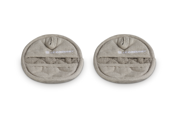 Two beige pot holders with brand logo on a white background