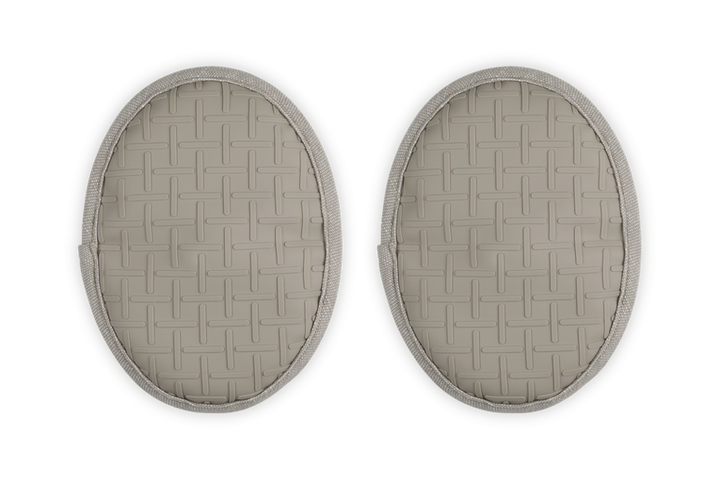 Two oval-shaped beige pot holders with a woven pattern on a white background