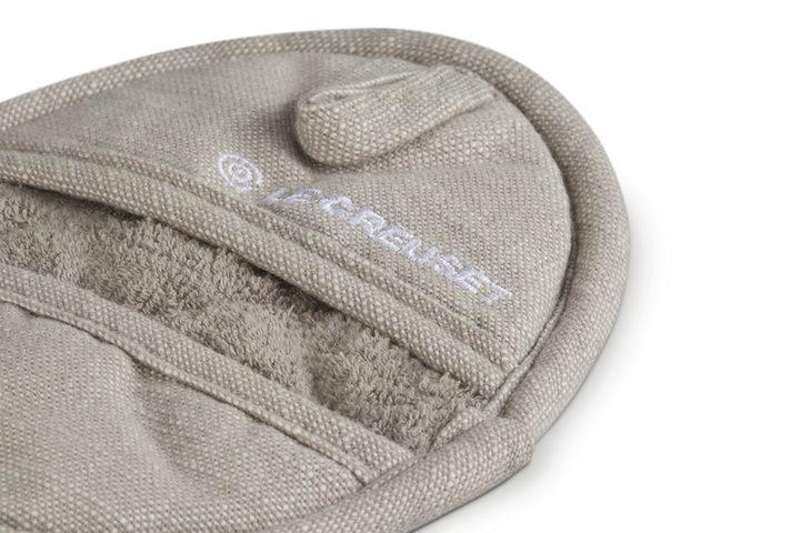 Beige pot holder with a visible brand logo on a white background