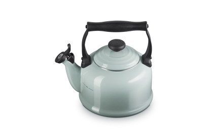 Light green kettle with black handle and lid knob on a white background