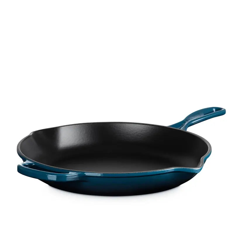 Blue cast iron skillet on a white background
