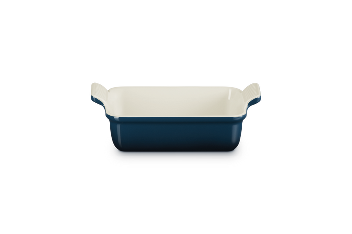 Blue rectangular baking dish with white interior on a white background