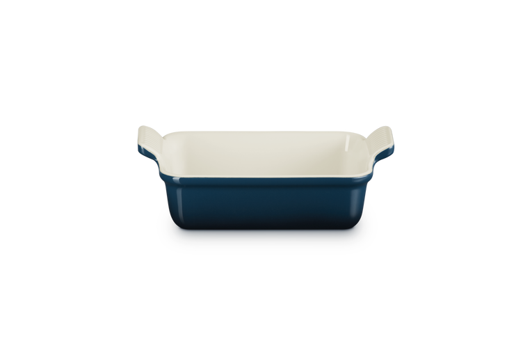 Blue rectangular baking dish with white interior on a white background