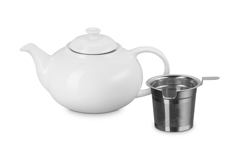White ceramic teapot with a stainless steel infuser basket on a white background