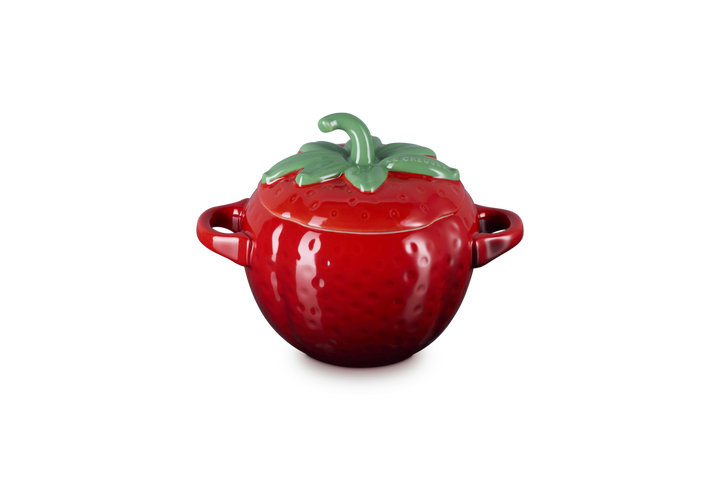 Red ceramic pot shaped like a strawberry with a green lid on a white background