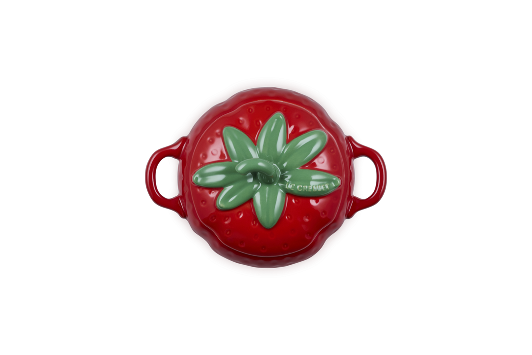 Red ceramic pot with strawberry design on a white background